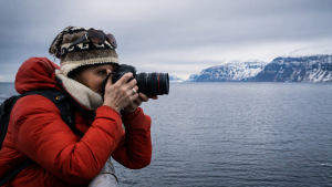 woman photographing in arctic environment on svalbard