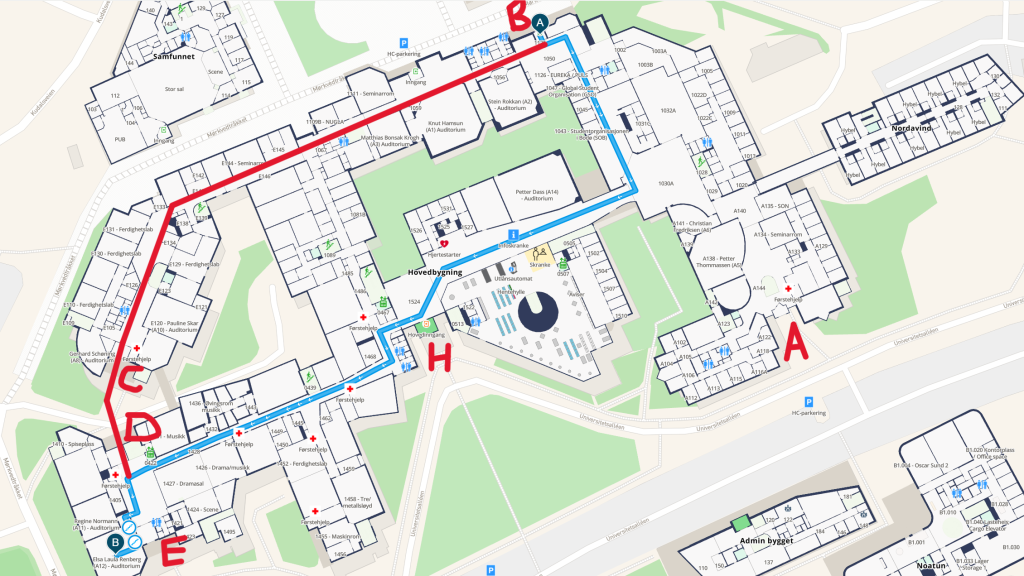 Map from MazeMap with additional marking showing two possible routes from entrance B of the university's main building to room A11 and A12 where the symposium is held. The first route goes to the left and then continue down the first hallway to the right, continuing straight and then taking the first hallway to the right. It then continues straight, keeping the university library on the left and a few aduitoria and the reception on the right. When having the main entrance on the left hand side, the route continues down the hallway straight ahead and then takes a left and then takes a right turn. It thereafter continues straight on until reaching the open area between entrance D on the right and E on the left. Turning left here, the last door on the right enters into a small room where the entrance to A11 is straight ahead and the entrance to A12 is on the right. The other route follows the hallway rightwards from entrance B and keeps straight on when another hallway branches off to the left. It takes a left turn when the building does, and then keeps straight on and exits this branch of the main building through entrance E, entering the other branch through entrance D across from E. The last door on the right enters into a small room where the entrance to A11 is straight ahead and the entrance to A12 is on the right.