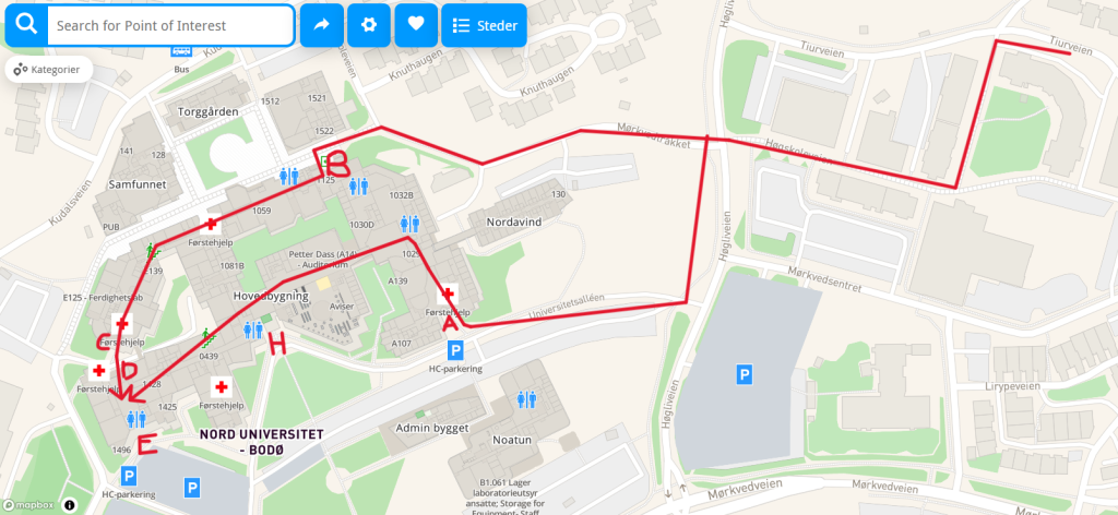 Map from MazeMap with additional marking showing two possible routes from the bus stop Hokkåsterassen to the venue. Both routes start by staying on the same side of the road and keeping the road on the right hand side and a building on the left hand side, taking a left at the corner of this building. Walking between this building and the building next to it, it takes the first right at the end of the latter building. It then continues straight along the walking path between several buildings until reaching a road and crossing it via the zebra crossing straight ahead. The routes diverge after corssing this road. The first route follows the pavement by the small road straight ahead, and continues on the walking path branching rightwards when this road stops (the road has already branched off to the left once). At the next juncture in this walking path, the route follows the left branch which goes between the cfeteria building on the right and the main building of the university on the left. It enters the main building through entrance B, which is direcctly opposite the cafeteria, and goes through the building to the rooms from there.